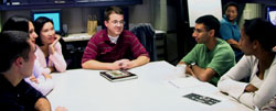 Researchers sitting around table in discussion